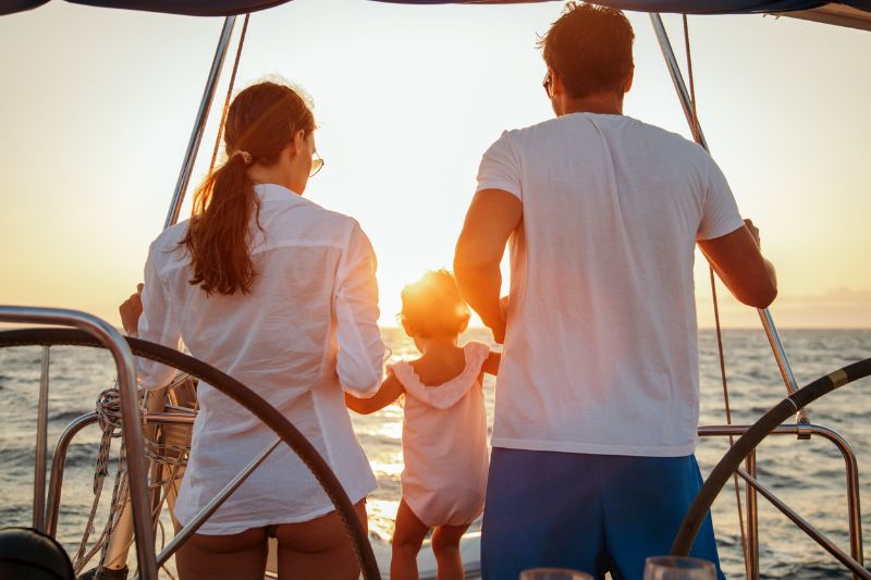 family with baby girl enjoying sailing